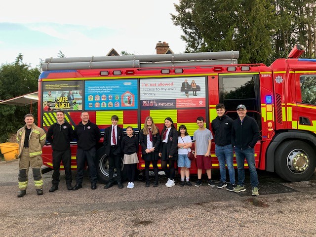 Youth Council standing with Cranleigh Fire Service by fire engine