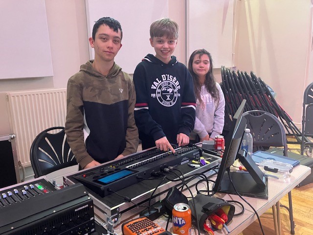 Three Youth Councillors learning how to use theatre lights and sound desks